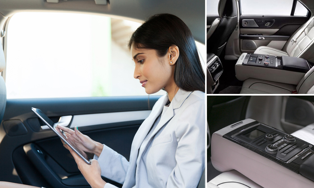Woman looking at a tablet while sitting in a Lincoln Continental.