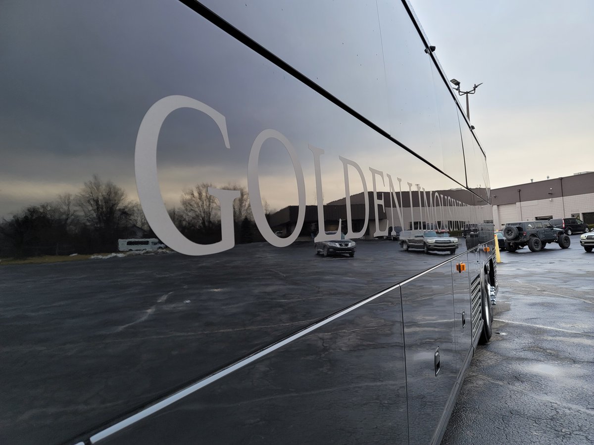 Exterior side view with focus on logo on Golden Limo Charter Bus