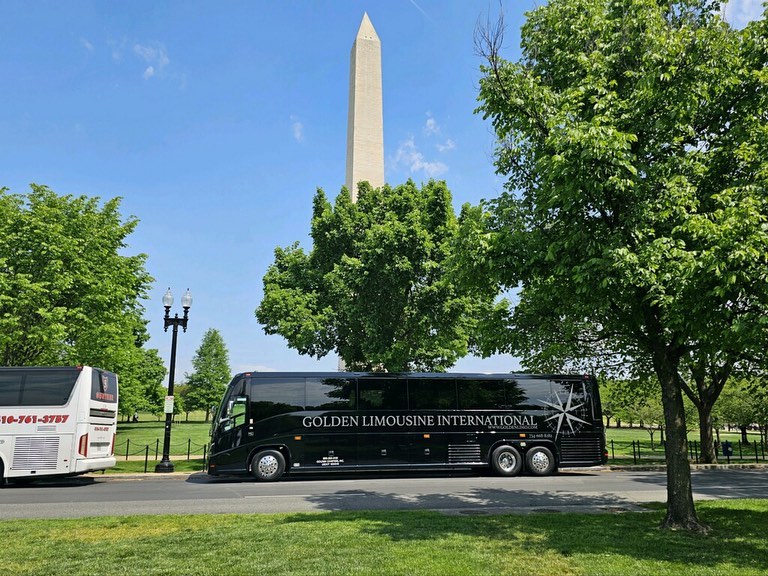 Golden Limo Charter Bus parked outside Washington Monument in Washington, DC.