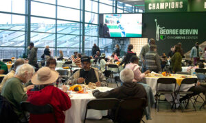 Image of community members dining during EMU's Thankful For You community Thanksgiving dinner event & fundraiser