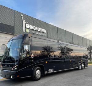 Exterior image of Golden Limo Charter Bus parked outside EMU'S George Gervin GameAbove Center