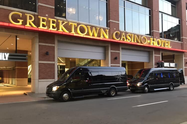 Golden Limousine Shuttle Vans sitting in front of Greektown Casino