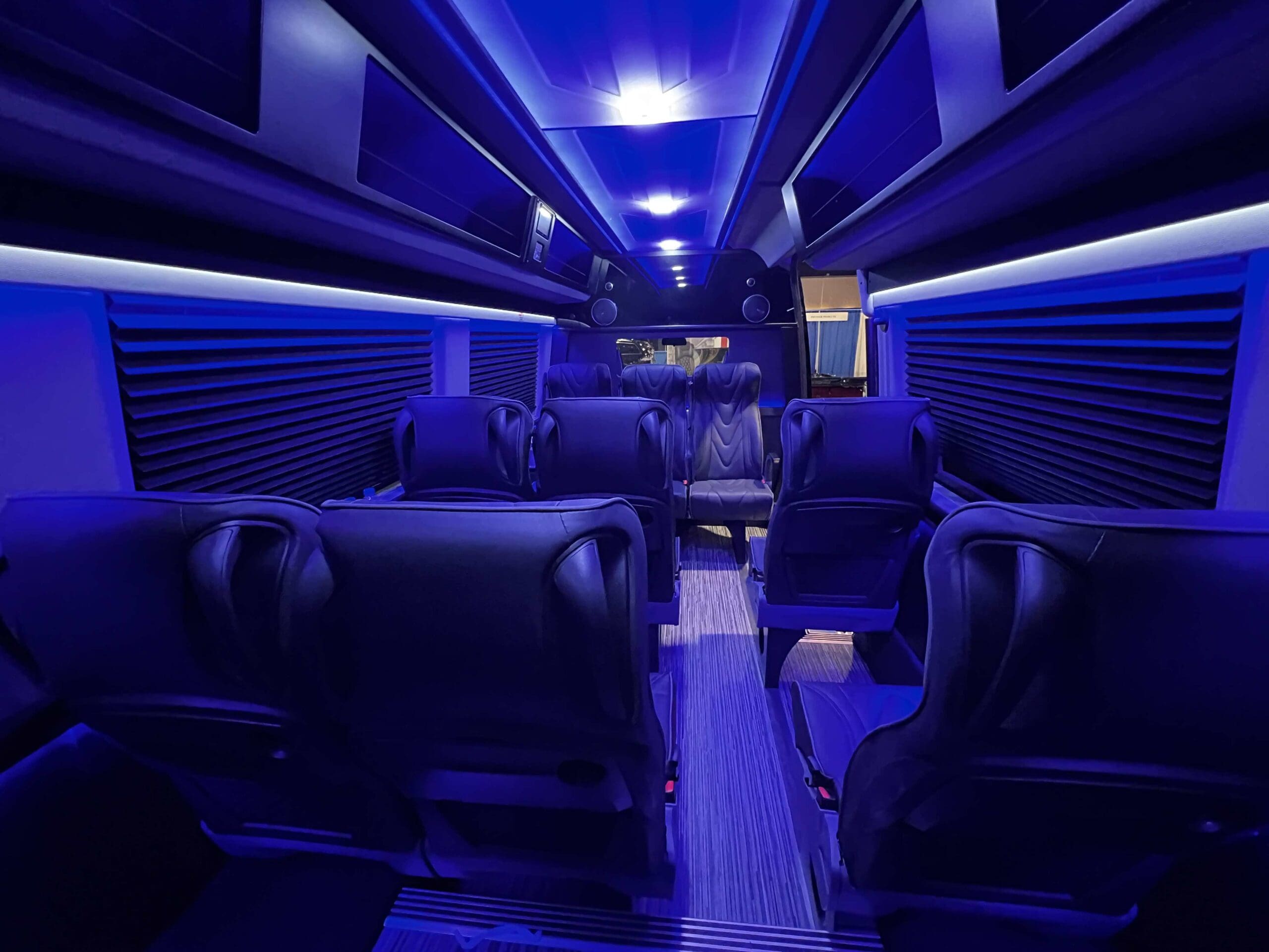 Golden Limo Executive Sprinter Shuttle, interior view from back row of seating with blue LED lights illuminating passenger cabin