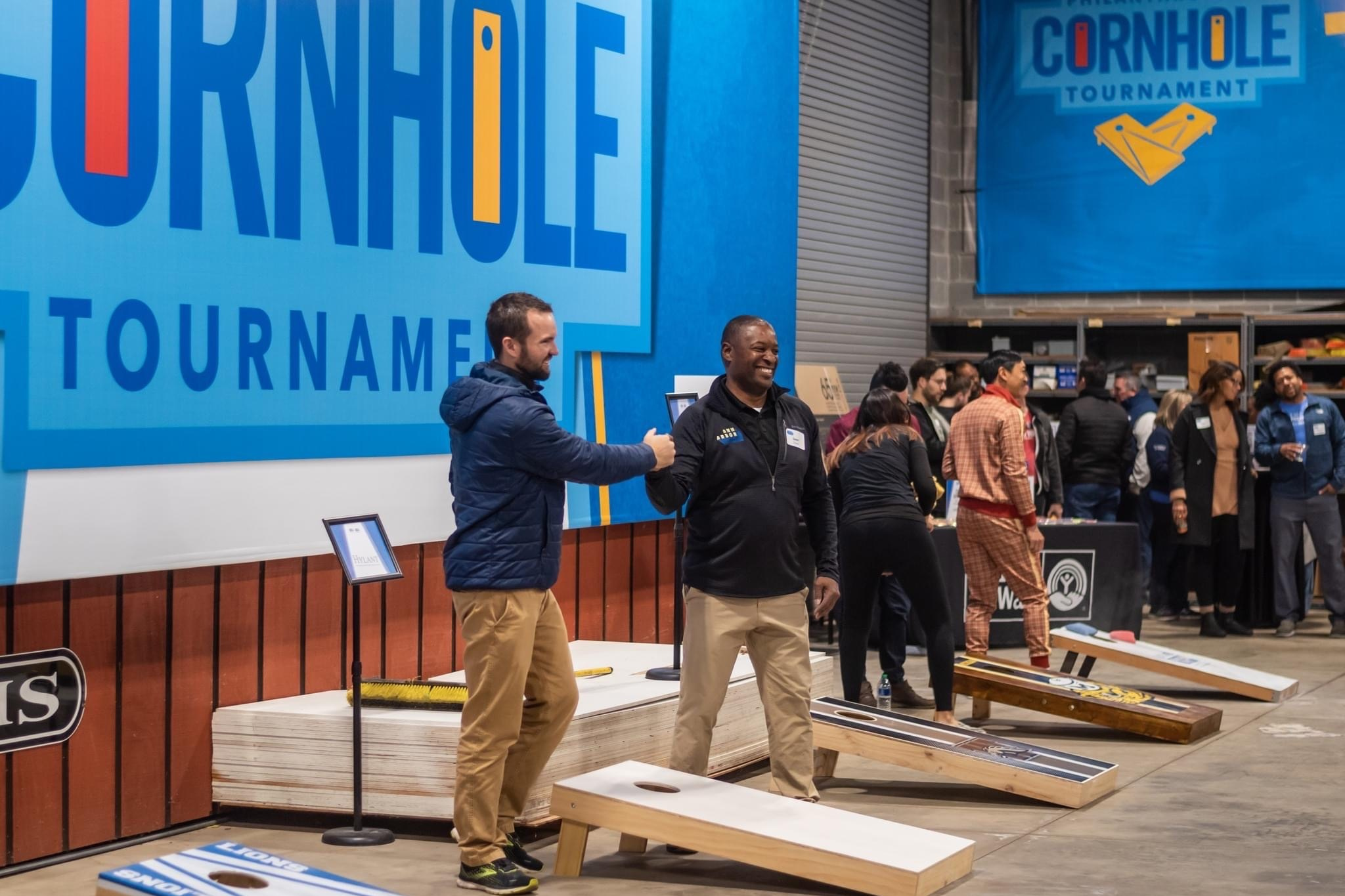 Golden Limousine International President & CEO Sean Duval playing cornhole at Shelter Association of Washtenaw County annual Cornhole tournament community fundraiser.