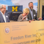 Golden Limousine International donates $10,000 to Freedom River at the Golden Ticket Wolverine Experience 2025.