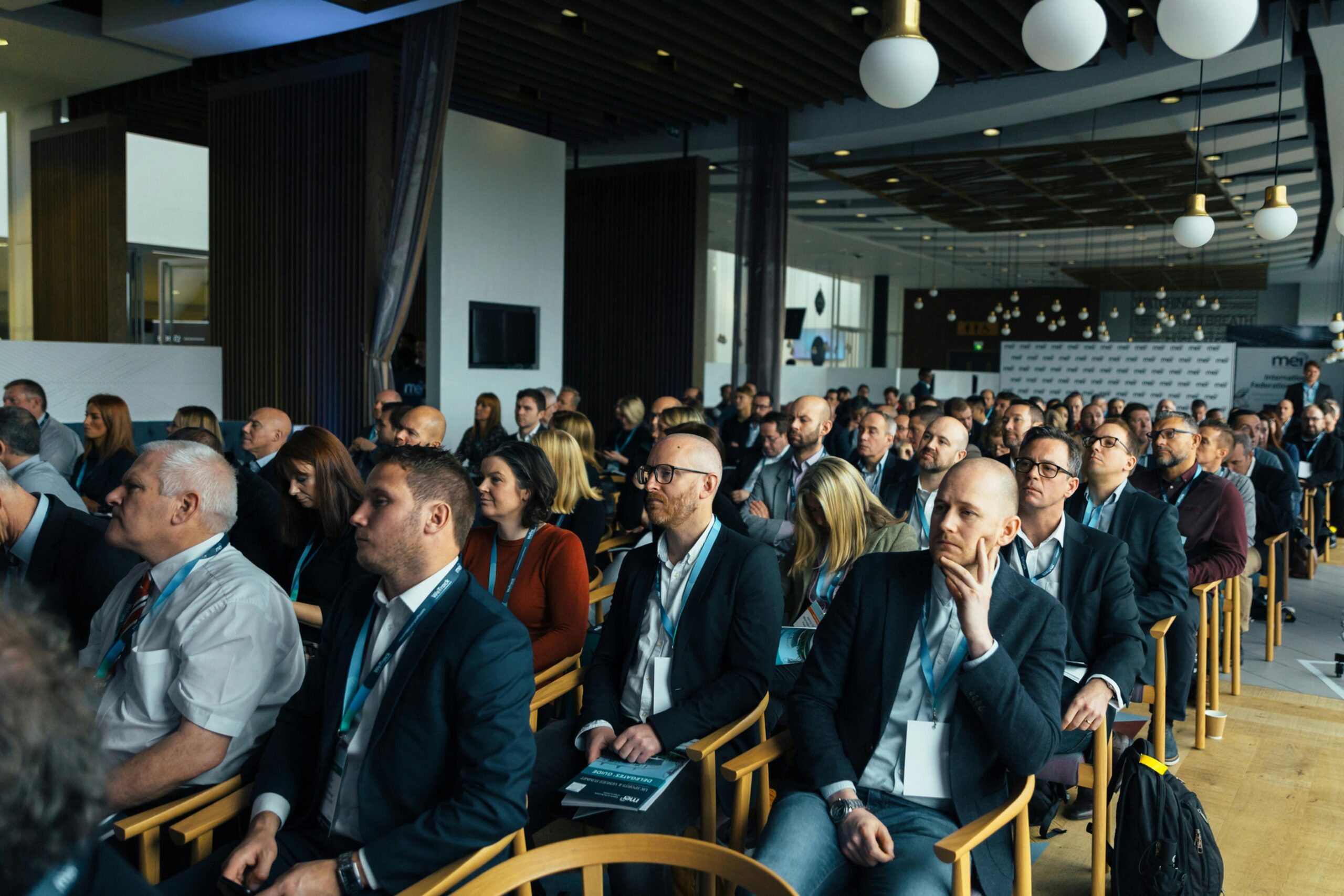 Large group of people sitting down at a corporate event.