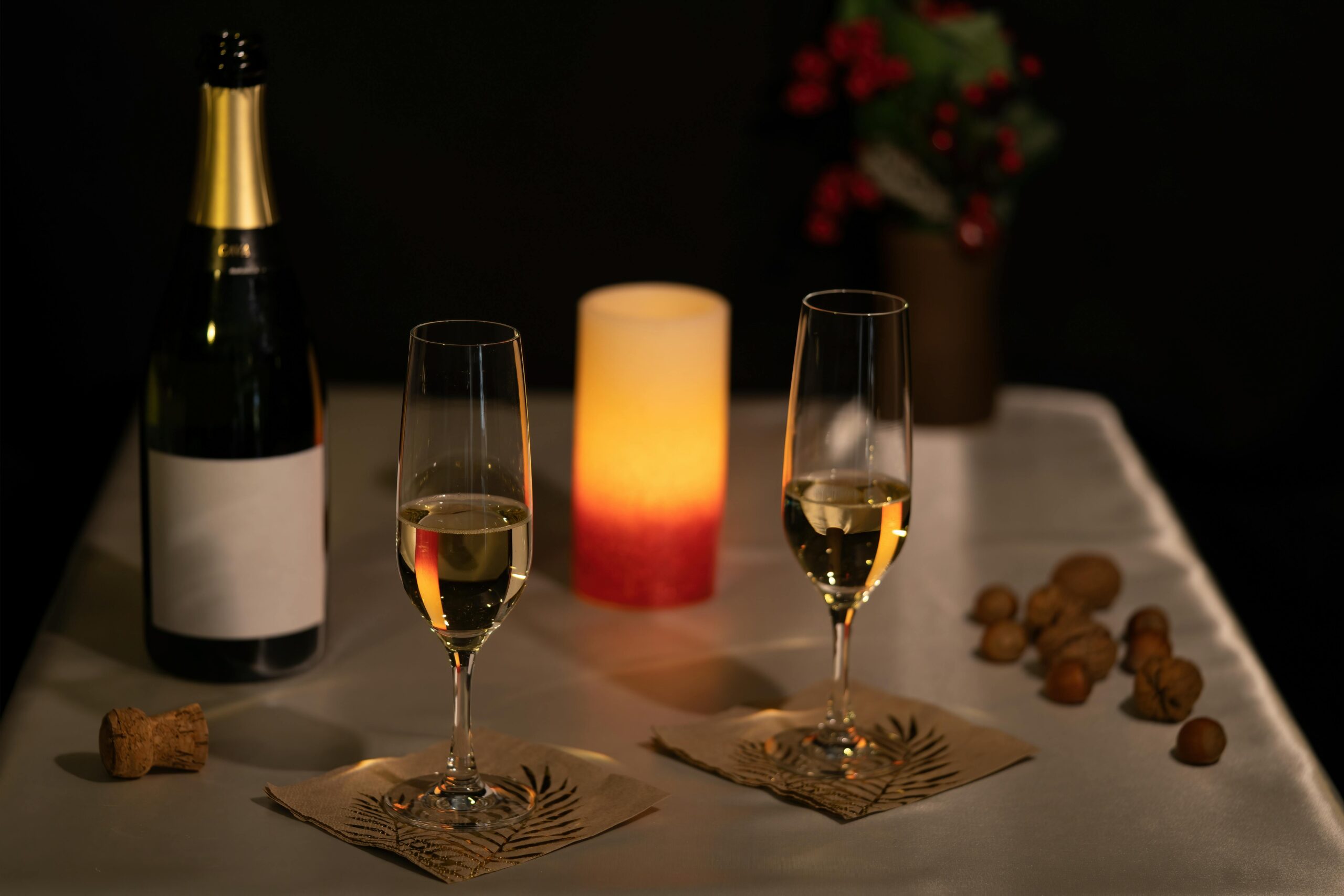 Two wine glasses and a bottle of wine setup on a romantic table for an anniversary.