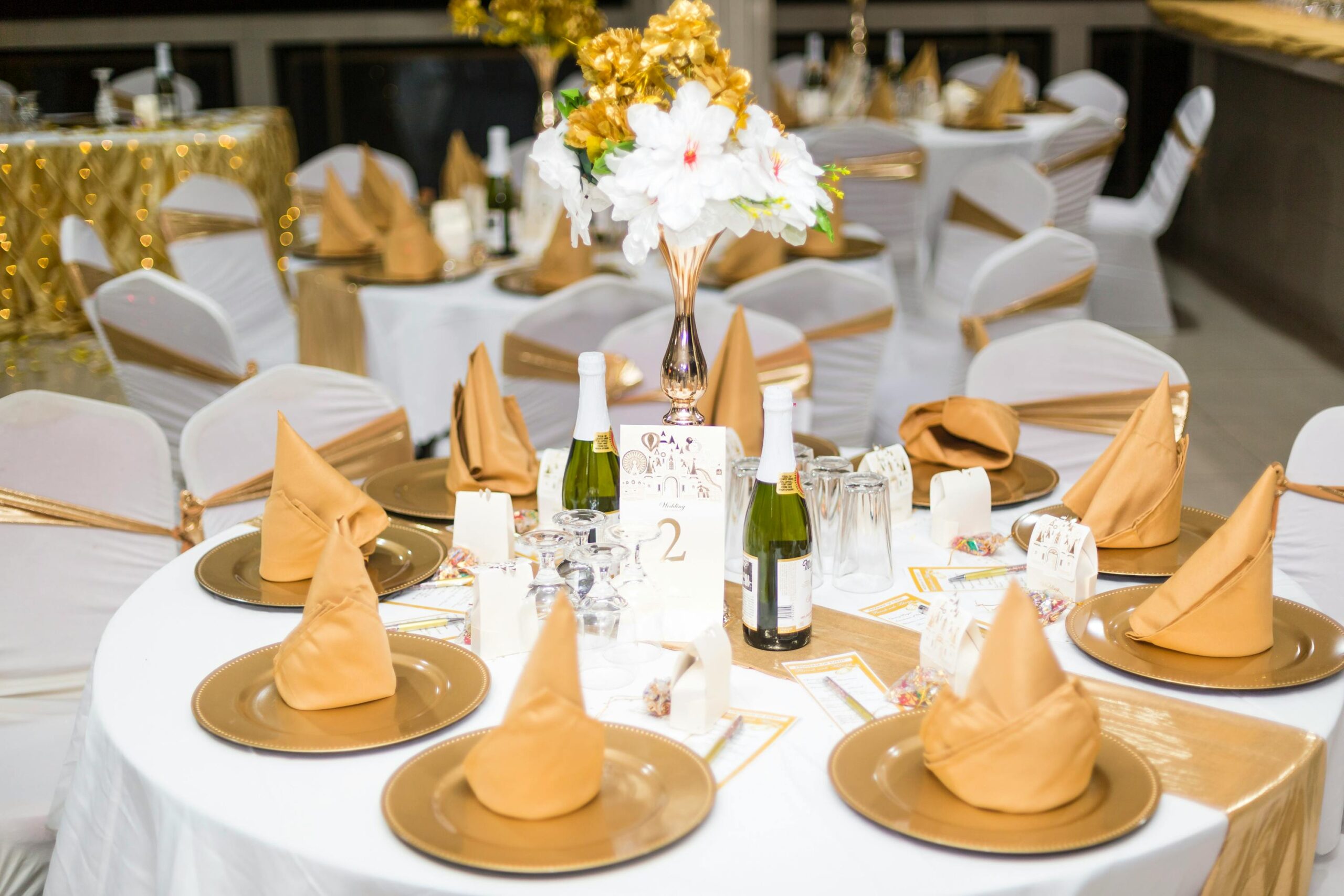 Gold and white table setup for a classy and luxury wedding.