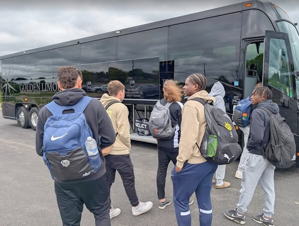 2025_06_GLI_AFC Partnership_AFC Mens Team Boarding Charter Bus.O The AFC Ann Arbor Men's team travels on a Golden Limousine International Motorcoach for all their away games!