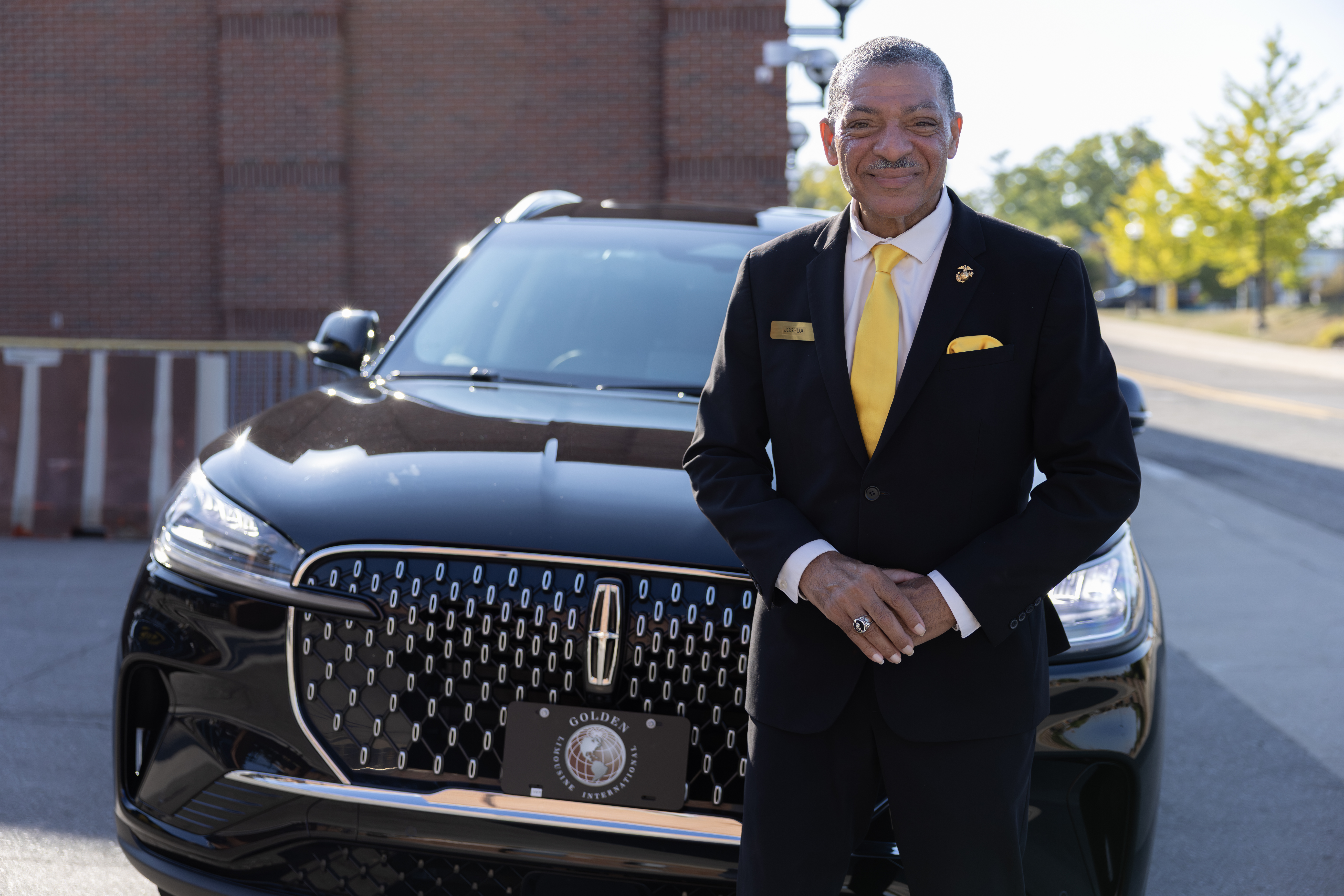 Golden Limousine International Chauffeur with a late model Aviator SUV.
