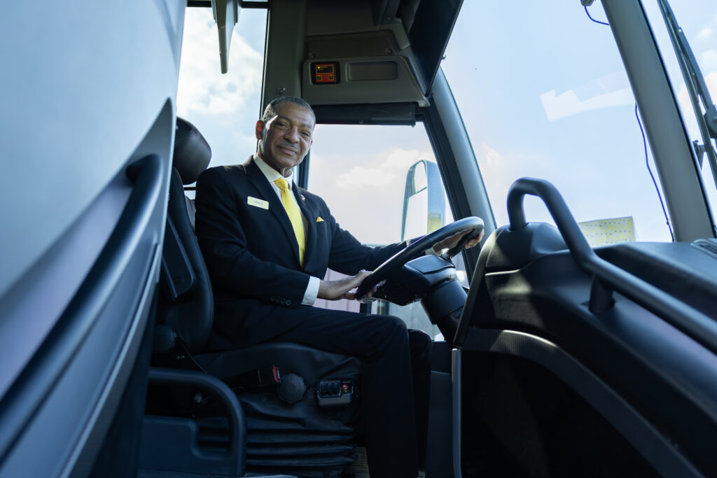 Golden Limousine charter bus driver in the driver's seat